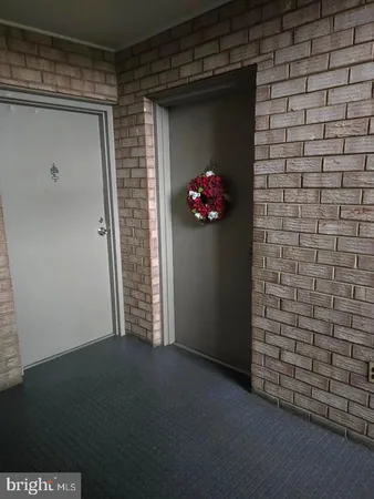 a view of a hallway with a bench