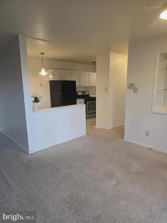 a view of a room with kitchen and a window