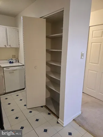 a kitchen with cabinets and white appliances