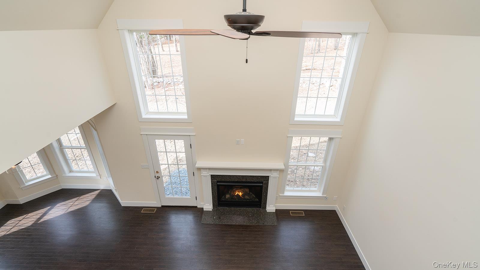 43 Malloy Road Wallkill, NY 12589 - Photo 21 of 50 Unfurnished living room featuring high vaulted ceiling, dark wood-style floors, a high end fireplace, and plenty of natural light