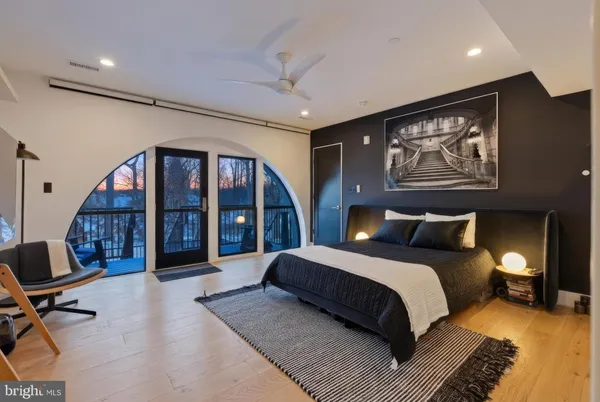 a bedroom with a large bed and a large window