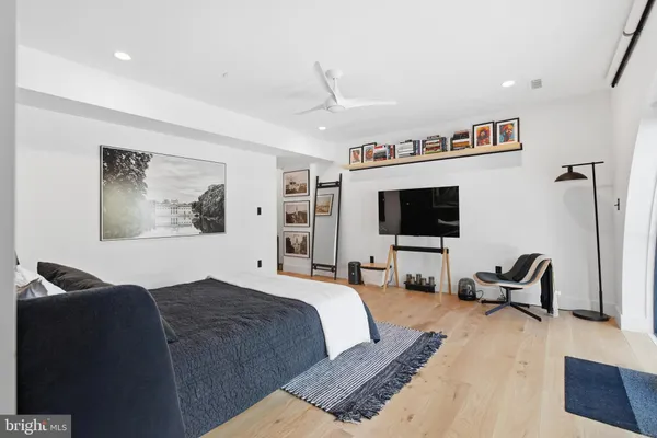 a spacious bedroom with a large bed and a large window