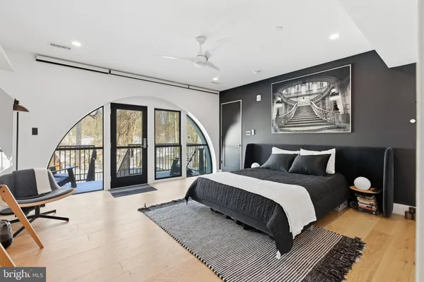 a bedroom with a large bed and paintings on the wall