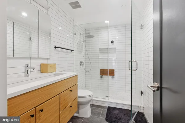 a balcony with wooden floor and outdoor seating