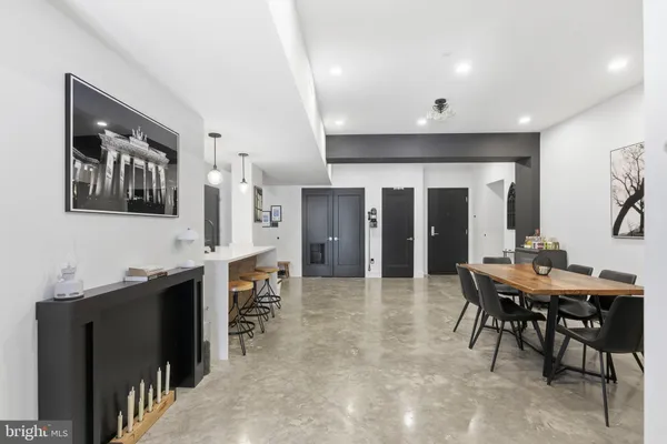 a large kitchen with a table and chairs in it