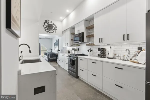 a kitchen with stainless steel appliances granite countertop a sink and cabinets