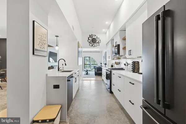a large white kitchen with stainless steel appliances