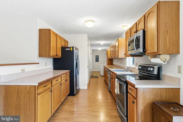 a kitchen with stainless steel appliances a sink and a refrigerator