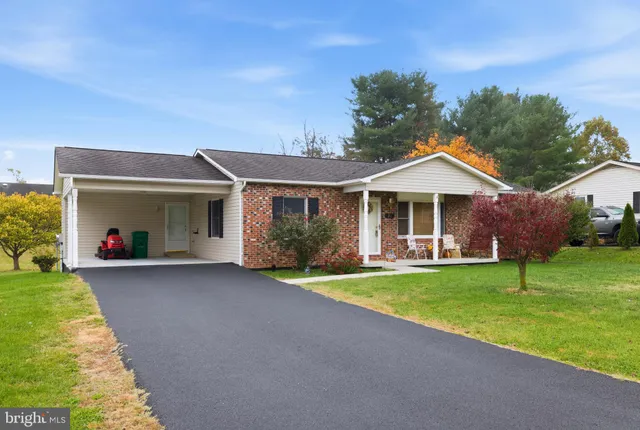 a front view of a house with a yard table and chairs