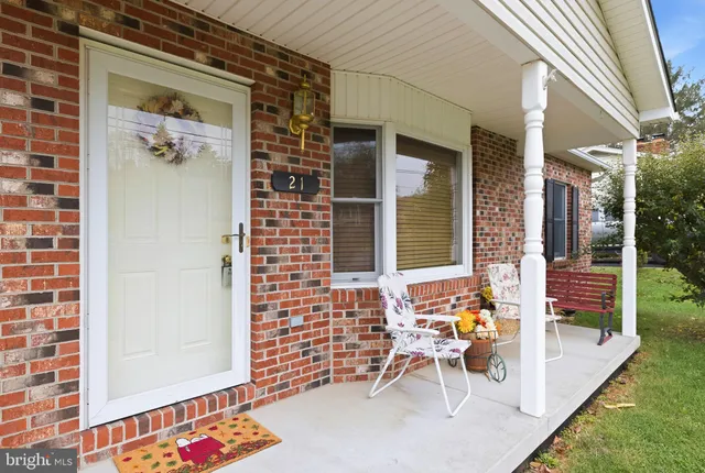 a view of a patio with table and chairs and potted plants