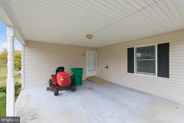 a view of a house with backyard and a tree