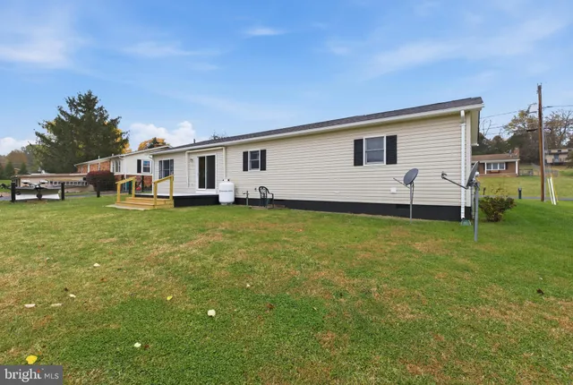 a view of a house with a backyard
