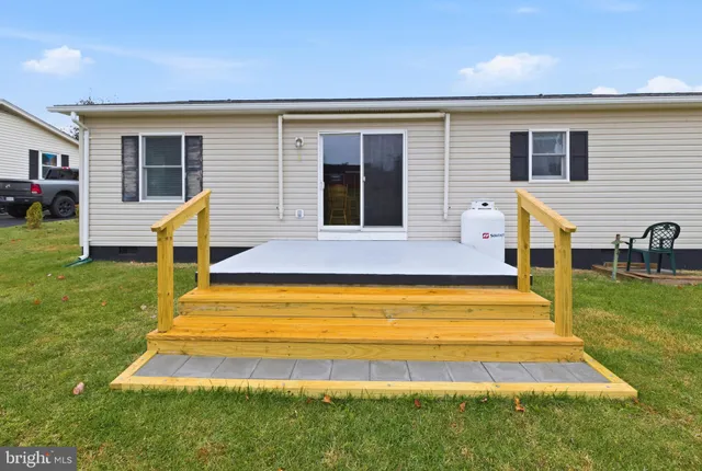 a view of a house with a backyard porch and sitting area