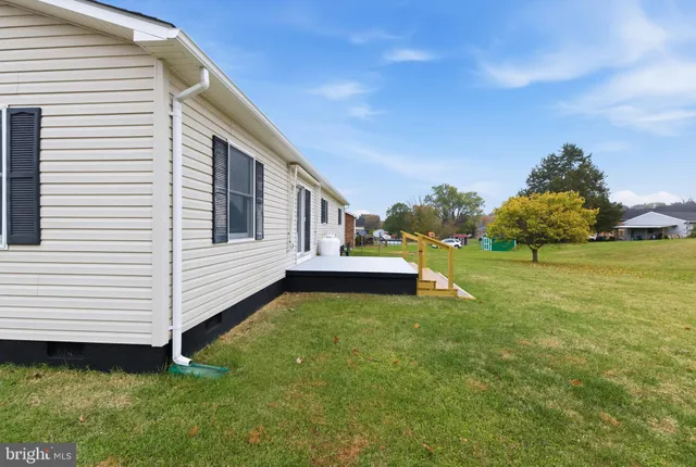 a view of yard with swimming pool and green space