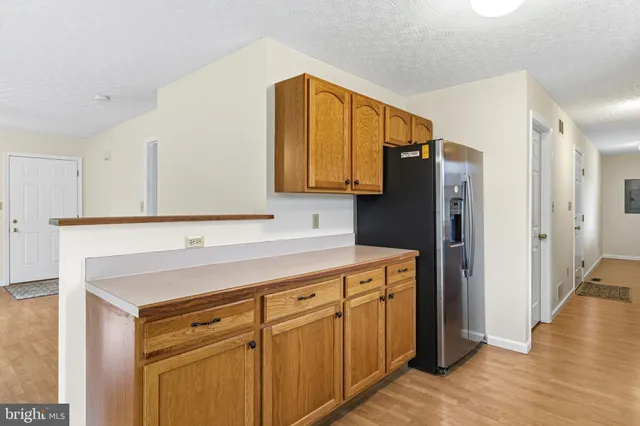a kitchen with a refrigerator and a sink