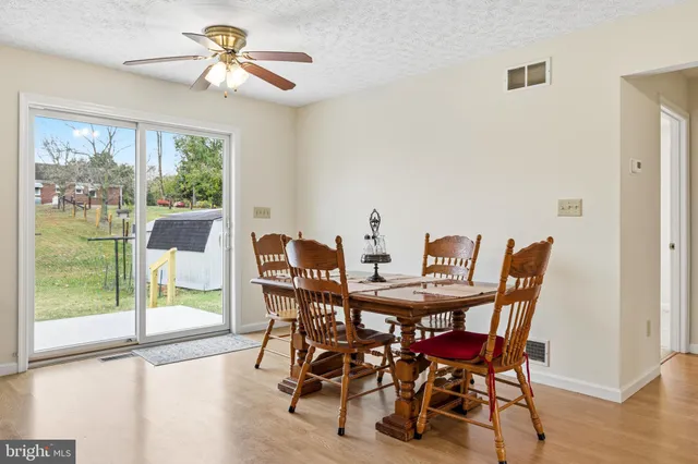 a view of a dining room with furniture and a fireplace