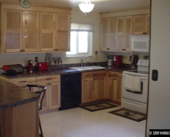1445 Locksley Way Reno, NV 89503 - Photo 3 of 8 a kitchen with a sink stove and cabinets