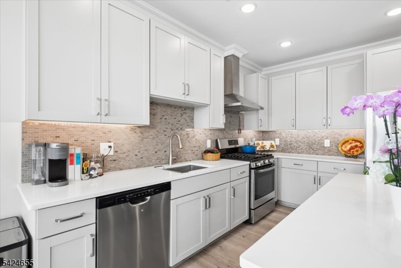 401 Mariners Pointe Hopatcong, NJ 07843 - Photo 14 of 42 a kitchen with a sink dishwasher and white cabinets