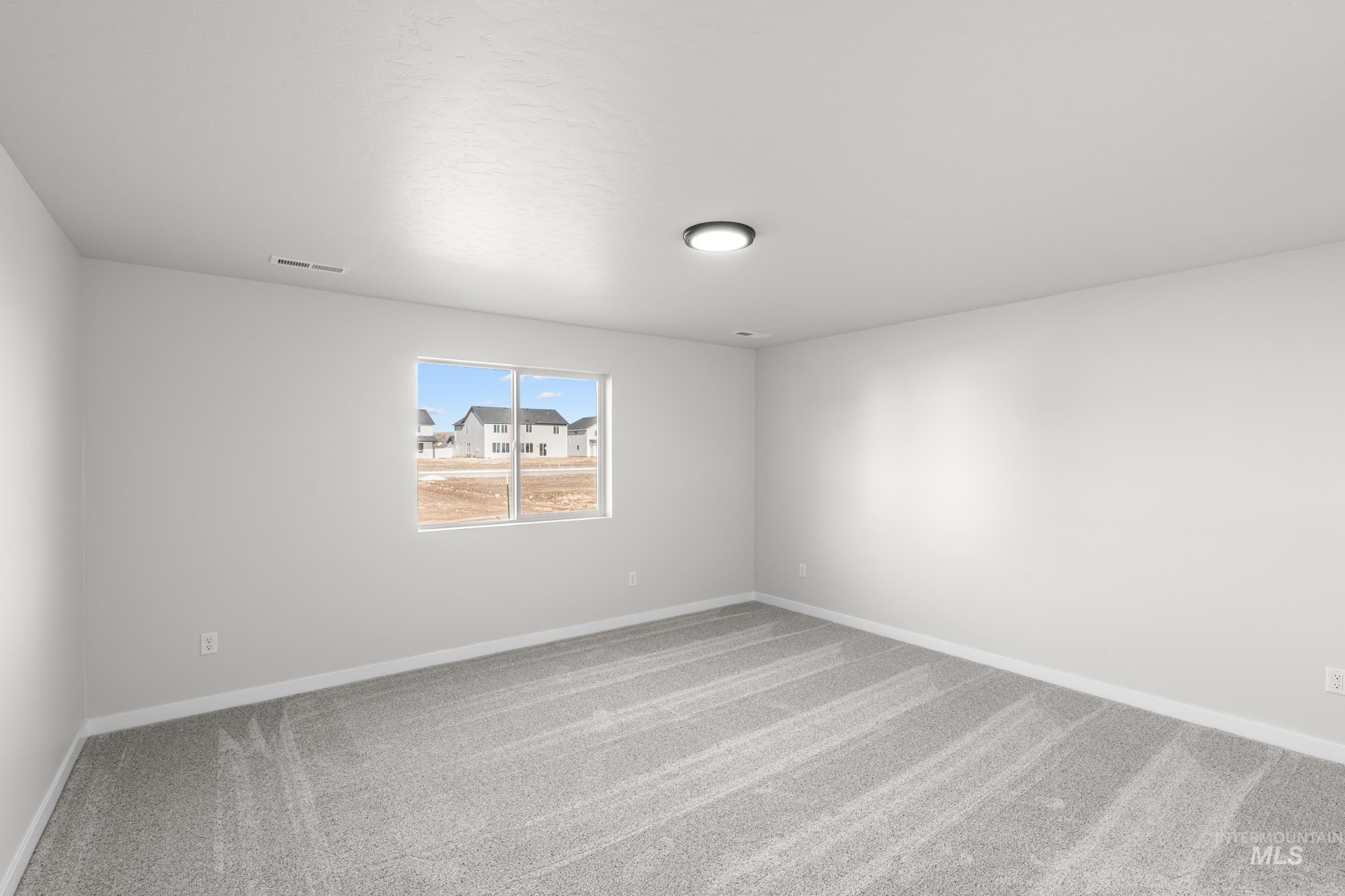 1622 Covington Street Middleton, ID 83644 - Photo 13 of 19 Empty room featuring carpet floors and baseboards