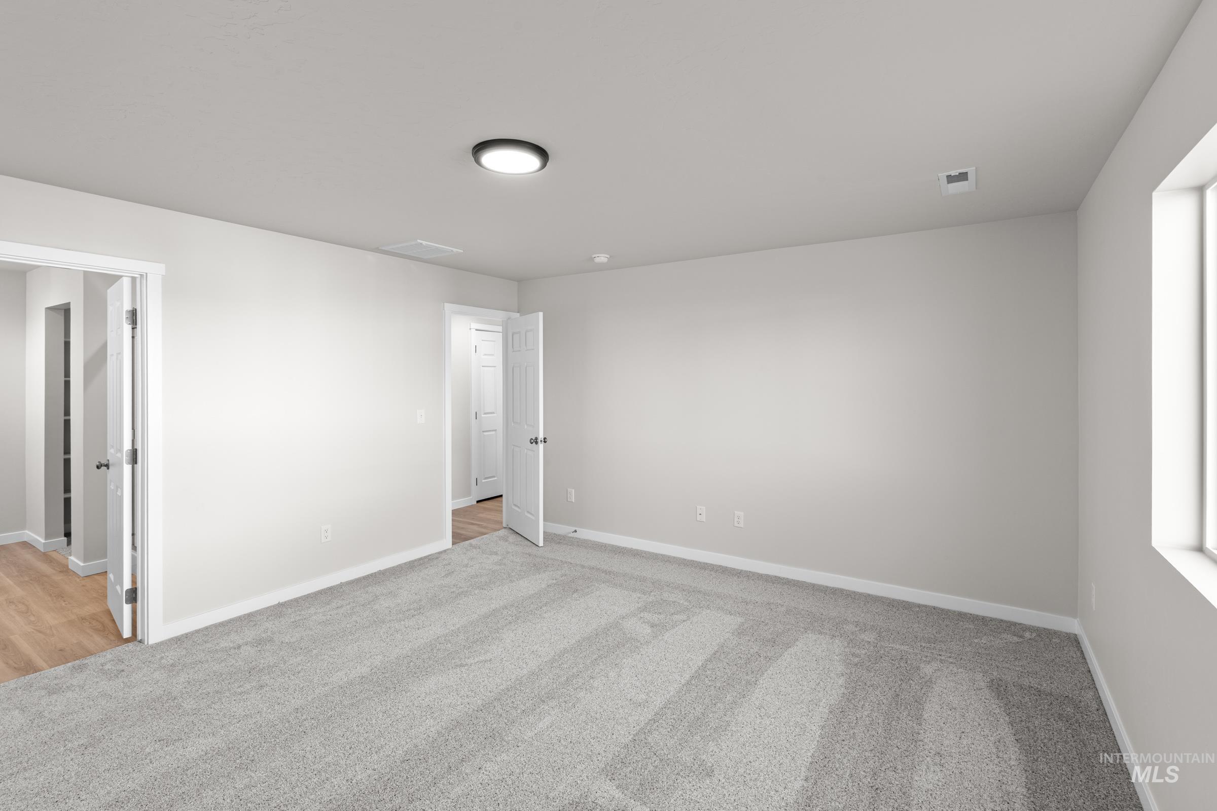1622 Covington Street Middleton, ID 83644 - Photo 14 of 19 Empty room with light colored carpet and baseboards