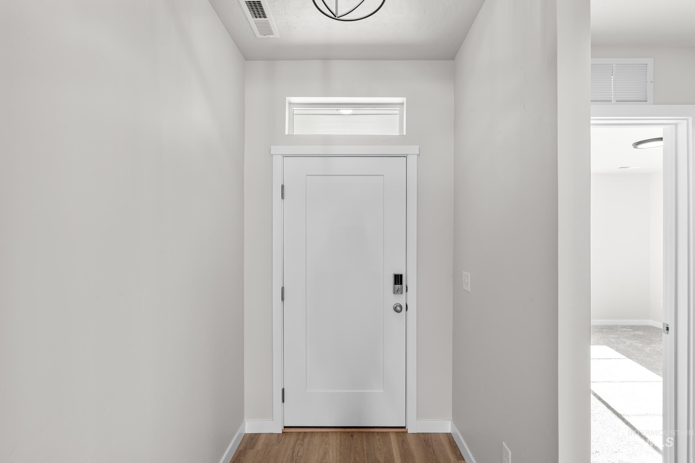 1622 Covington Street Middleton, ID 83644 - Photo 2 of 19 Doorway to outside with baseboards and wood finished floors