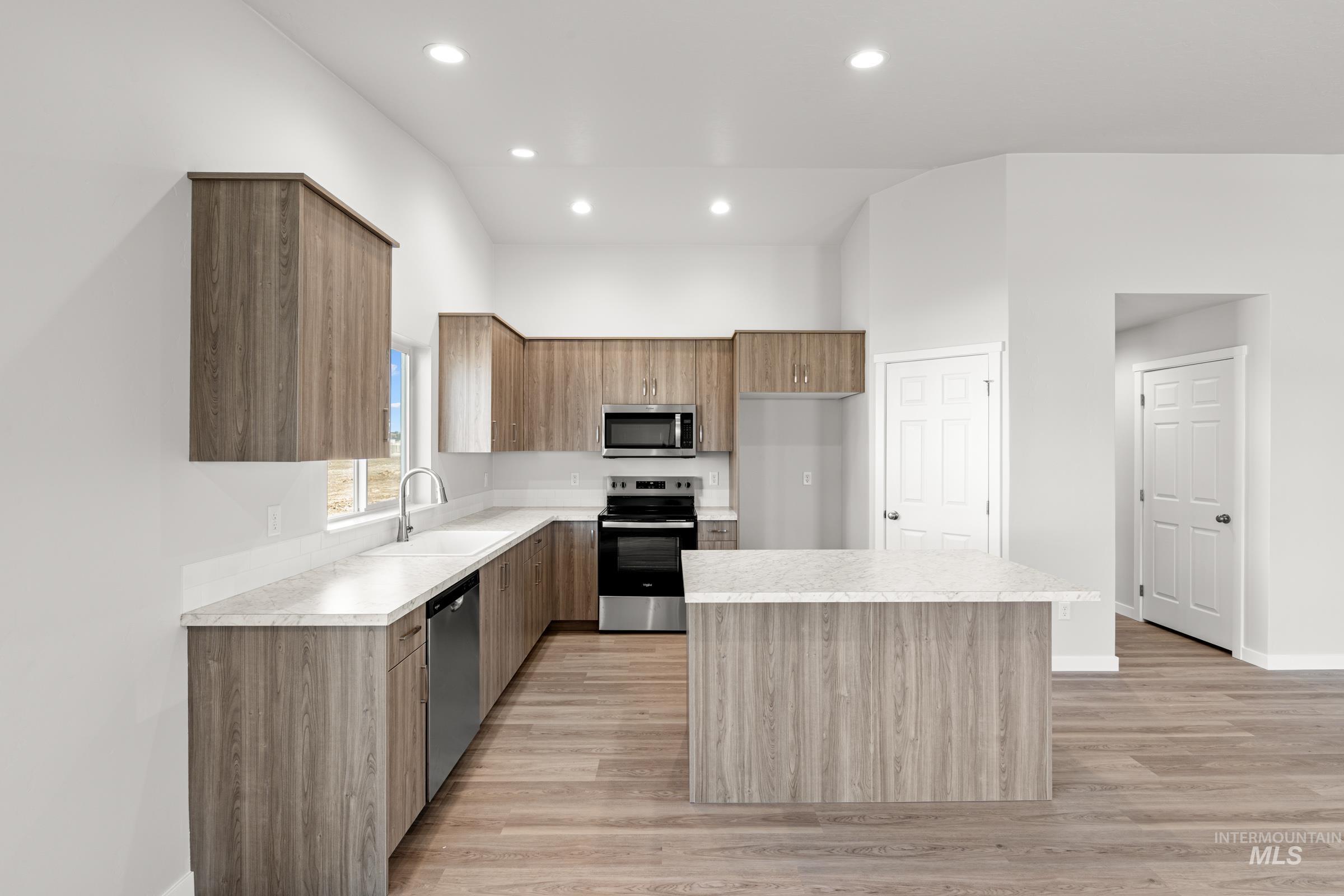 1622 Covington Street Middleton, ID 83644 - Photo 4 of 19 Kitchen featuring stainless steel appliances, a center island, modern cabinets, light countertops, and light wood finished floors