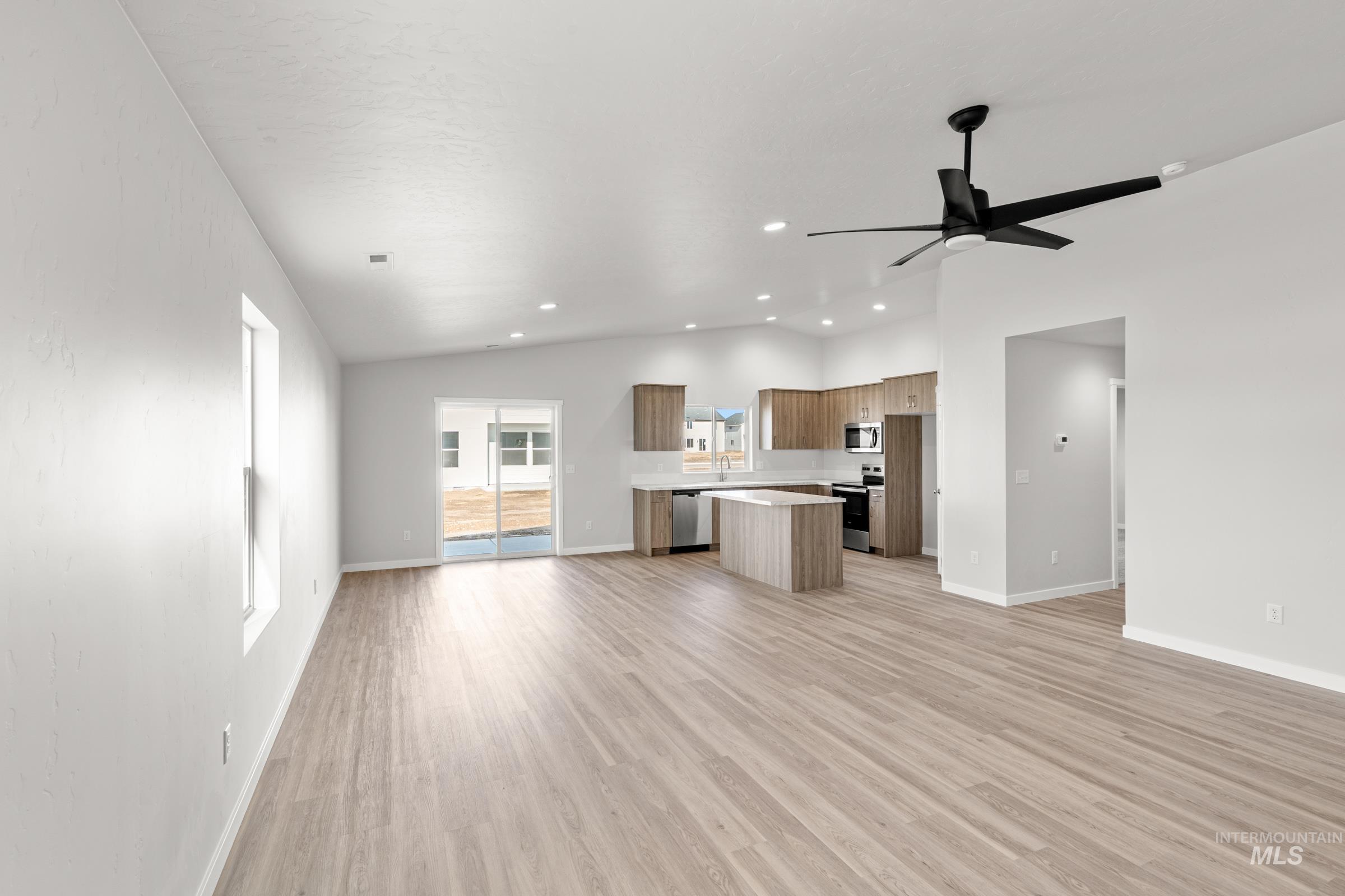 1622 Covington Street Middleton, ID 83644 - Photo 19 of 19 Kitchen featuring open floor plan, lofted ceiling, light wood-style flooring, light countertops, and a kitchen island