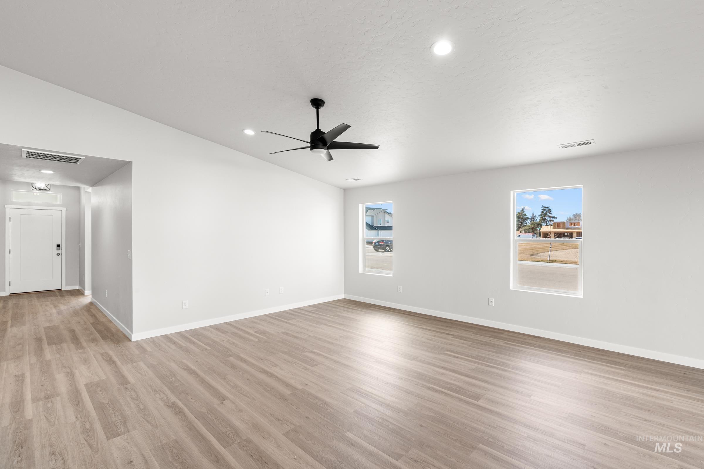 1622 Covington Street Middleton, ID 83644 - Photo 8 of 19 Empty room with vaulted ceiling, ceiling fan, light wood-style flooring, and recessed lighting