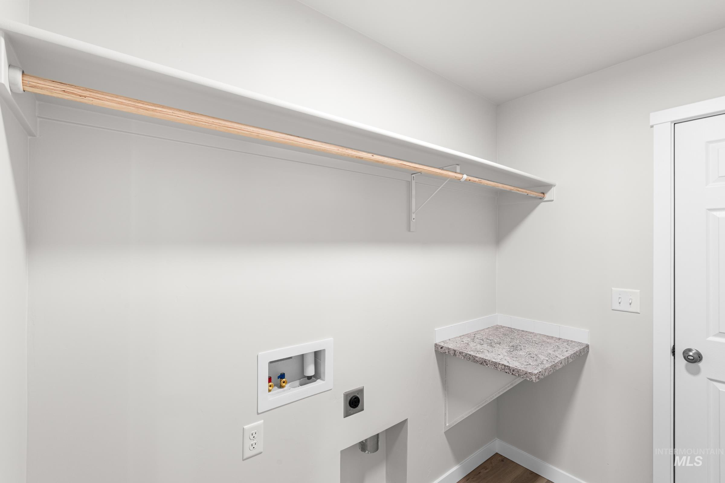 1622 Covington Street Middleton, ID 83644 - Photo 9 of 19 Laundry room featuring hookup for a washing machine, hookup for an electric dryer, and dark wood-style flooring