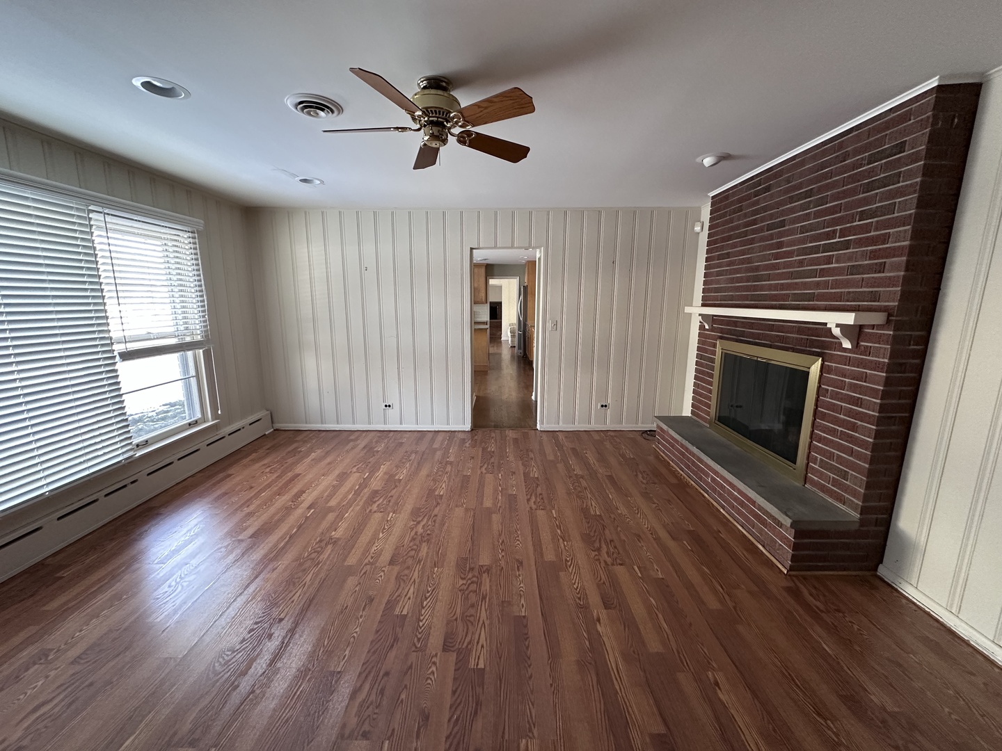 2300 Landwehr Road Northbrook, IL 60062 - Photo 16 of 28 an empty room with wooden floor fireplace and windows