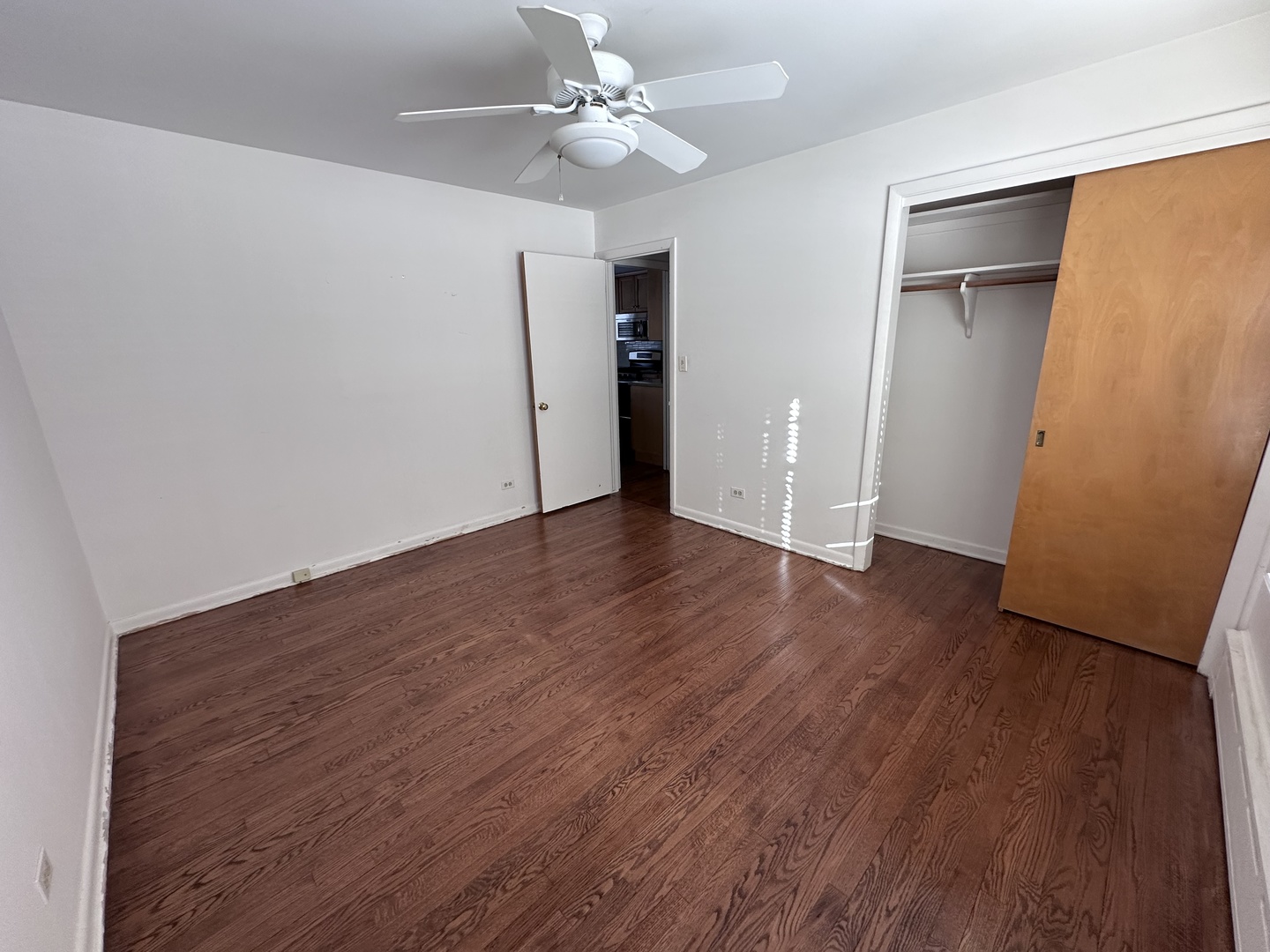 2300 Landwehr Road Northbrook, IL 60062 - Photo 18 of 28 an empty room with wooden floor and ceiling fan