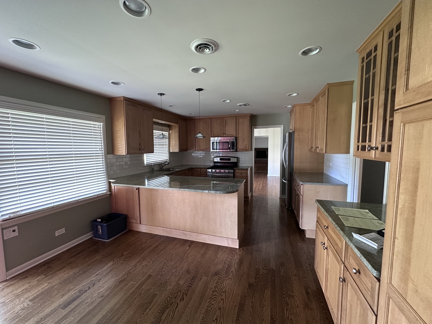 2300 Landwehr Road Northbrook, IL 60062 - Photo 6 of 28 a kitchen with stainless steel appliances granite countertop a refrigerator a stove top oven a sink dishwasher and wooden floor