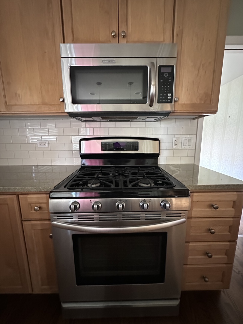 2300 Landwehr Road Northbrook, IL 60062 - Photo 8 of 28 a stove top oven sitting inside of a kitchen