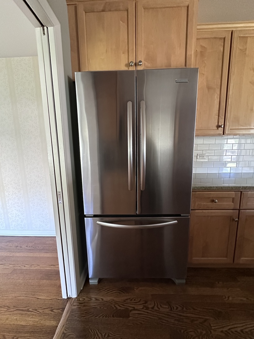 2300 Landwehr Road Northbrook, IL 60062 - Photo 9 of 28 a metallic refrigerator freezer sitting in a kitchen