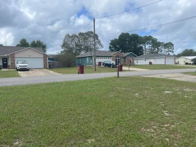 an empty room with fireplace and windows