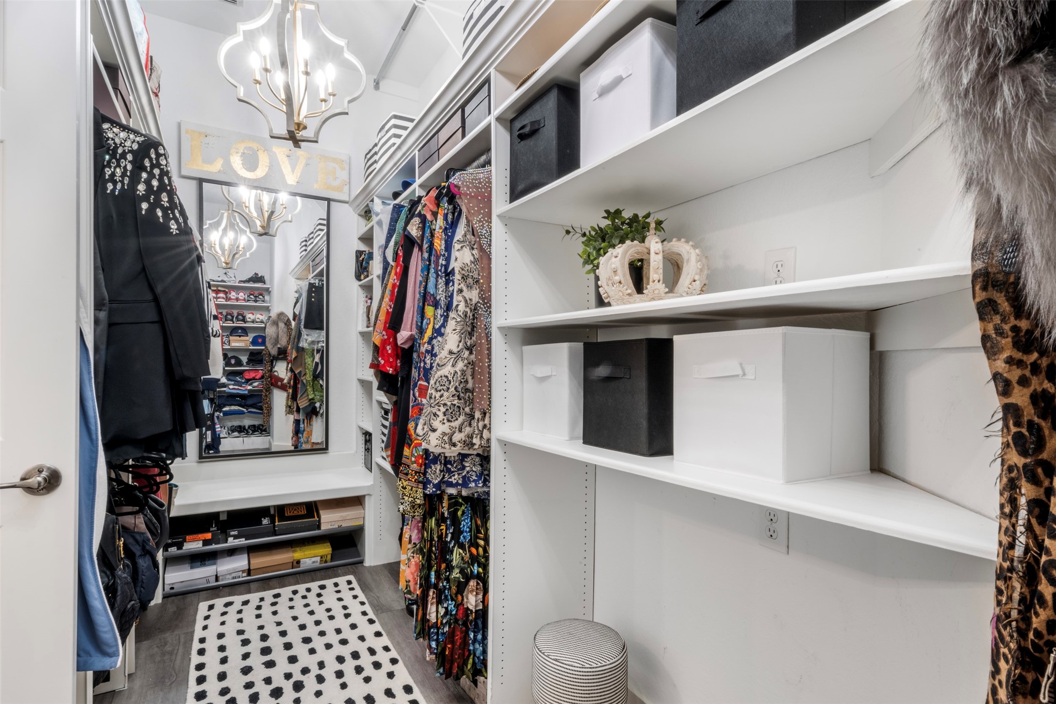 19527 Remington Manor Street Spring, TX 77379 - Photo 28 of 50 Dream closet! This is just a peek at it.. Just off of the primary bath, this custom storage space is complete with gorgeous pendant lighting, long wall mirror, ample shelving & rods all the way to the ceiling.