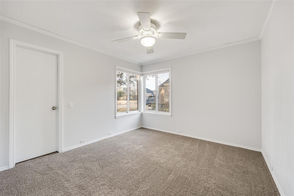 3919 Winter Park Lane Addison, TX 75001 - Photo 14 of 25 Spare room featuring crown molding, a ceiling fan, and carpet