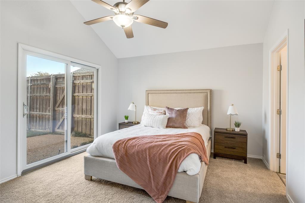 3919 Winter Park Lane Addison, TX 75001 - Photo 19 of 25 Carpeted bedroom featuring lofted ceiling, access to exterior, and a ceiling fan