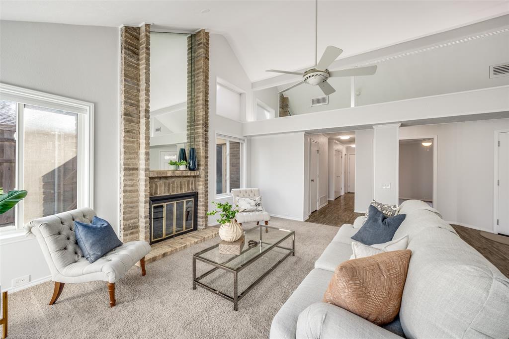 3919 Winter Park Lane Addison, TX 75001 - Photo 4 of 25 Living area with carpet floors, a ceiling fan, a brick fireplace, and lofted ceiling