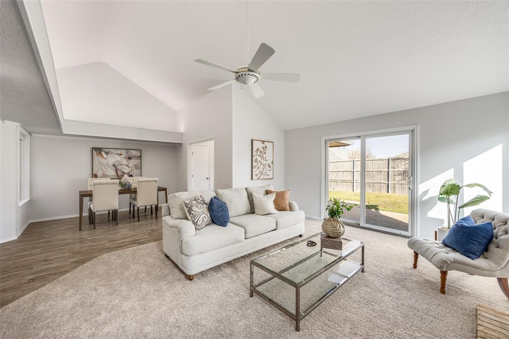 3919 Winter Park Lane Addison, TX 75001 - Photo 7 of 25 Living area with ceiling fan, vaulted ceiling, and wood finished floors
