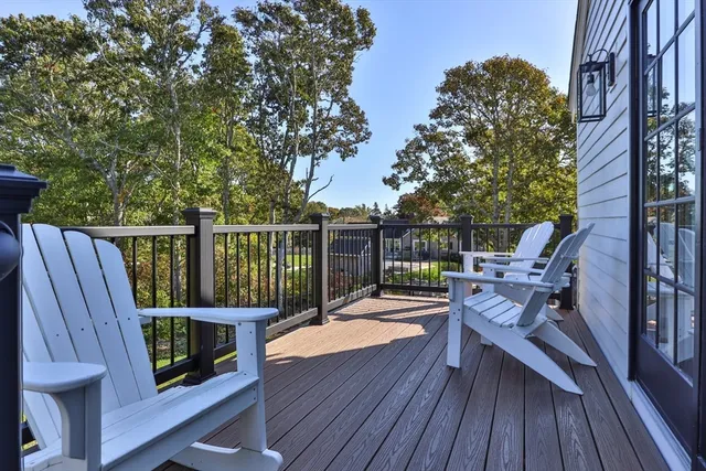 a view of a deck with wooden floor and outdoor seating