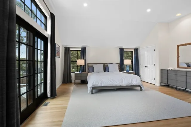 a bedroom with a large bed and a chandelier