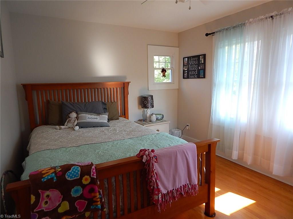 3990 Beasley School Road Sandy Ridge, NC 27046 - Photo 13 of 28 All bedrooms have wood flooring and neutral paint.