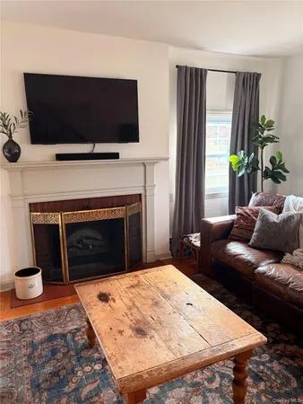 a living room with a fireplace and a flat screen tv