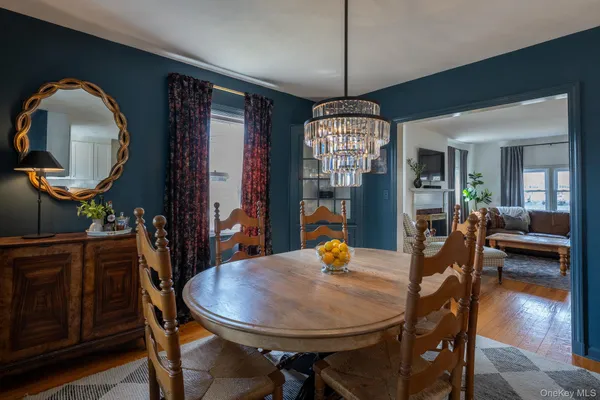 a view of a dining room with furniture and chandelier