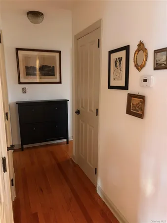 a view of a hallway with paintings on the wall