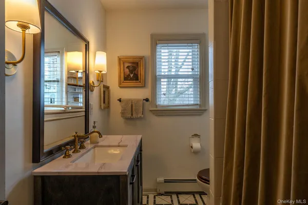 a bathroom with a sink a mirror and a window