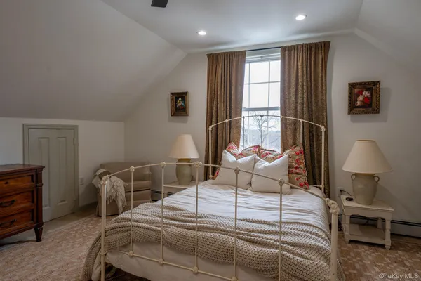 a bedroom with furniture and a window