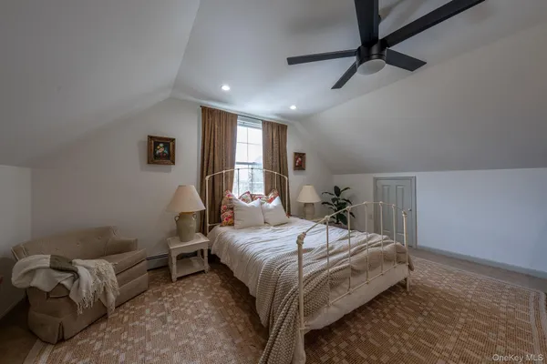 a bedroom with a bed and a couch