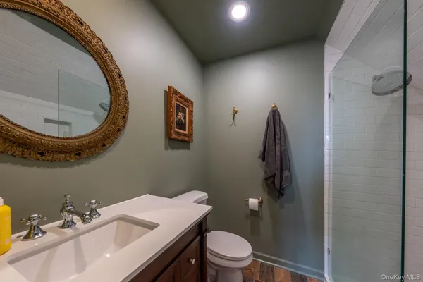 a bathroom with a toilet sink and mirror